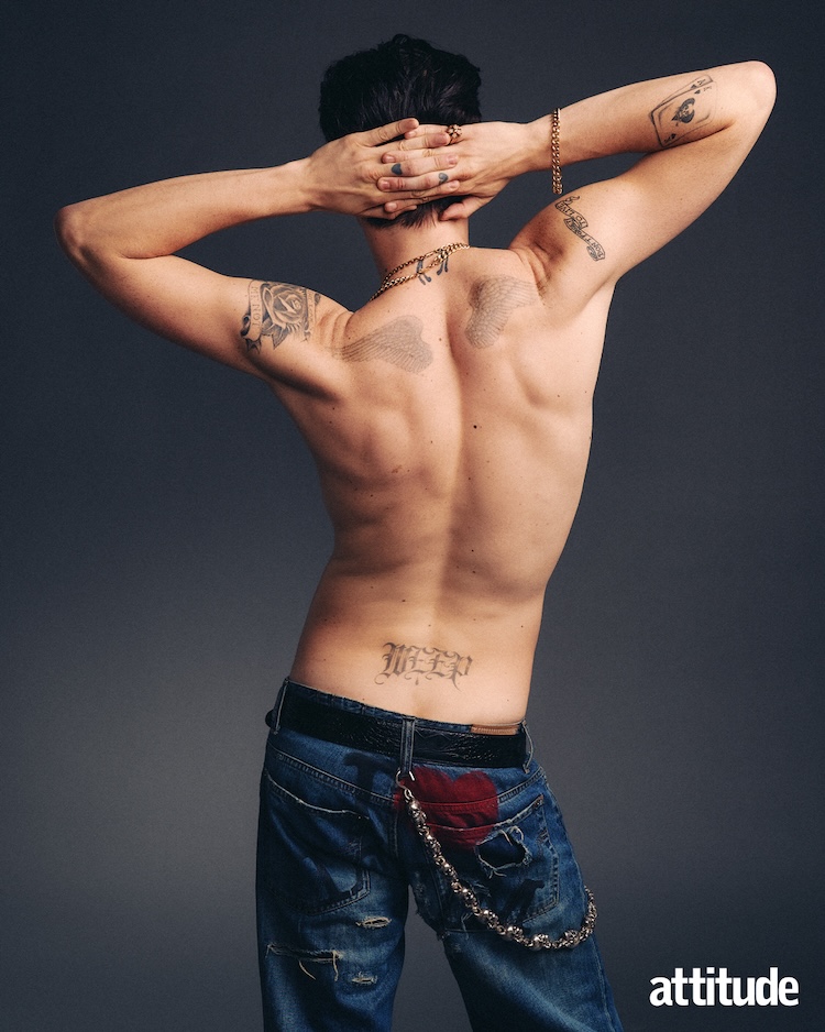 a shot of Yungblud topless taken from behind, him topless