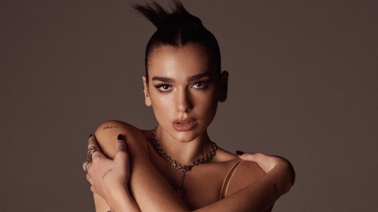 Did with hair up in a bra top with arms wrapped around herself