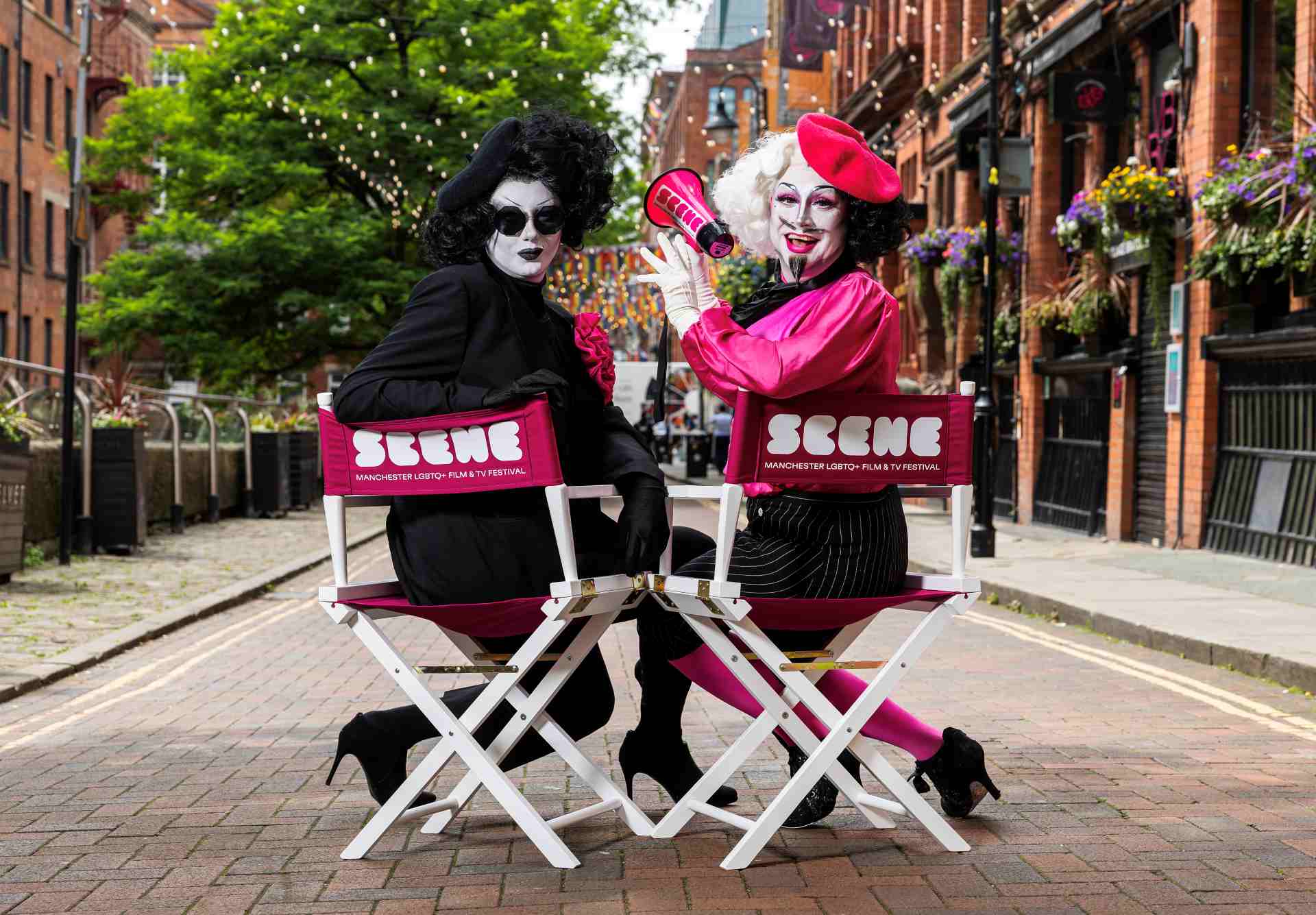 Anna Phylactic and Liquorice Black sit in SCENE-branded chairs on Canal Street in Manchester