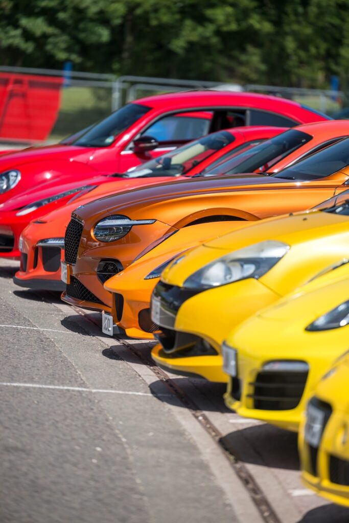 A gradient of cars lined up, starting red, then orange and then yellow