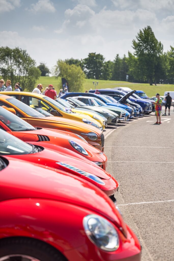 A line up for cars all different colours to look like a rainbow