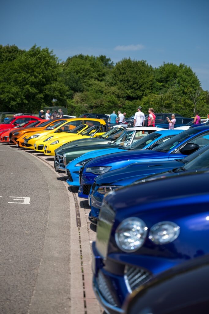 a gradient of cars, starting dark blue, then light blue, green and then yellow, orange and red