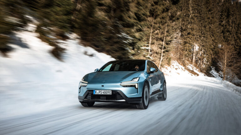 Polestar 4 in a teal blue driving through the snow