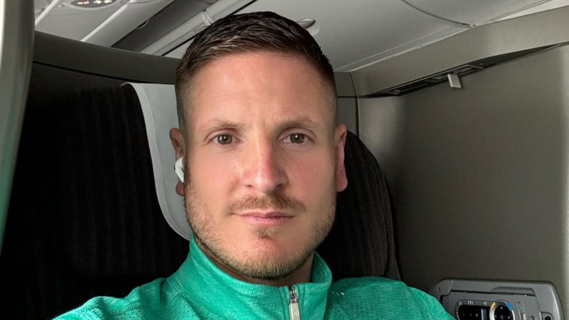 Ryan Atkin in a sporty green quarter zip