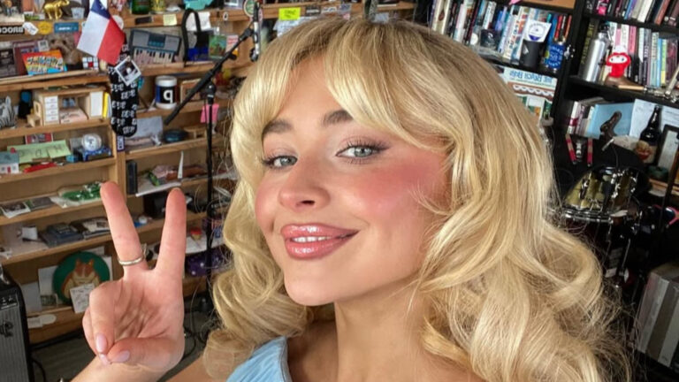 Sabrina Carpenter holding up a peace sign