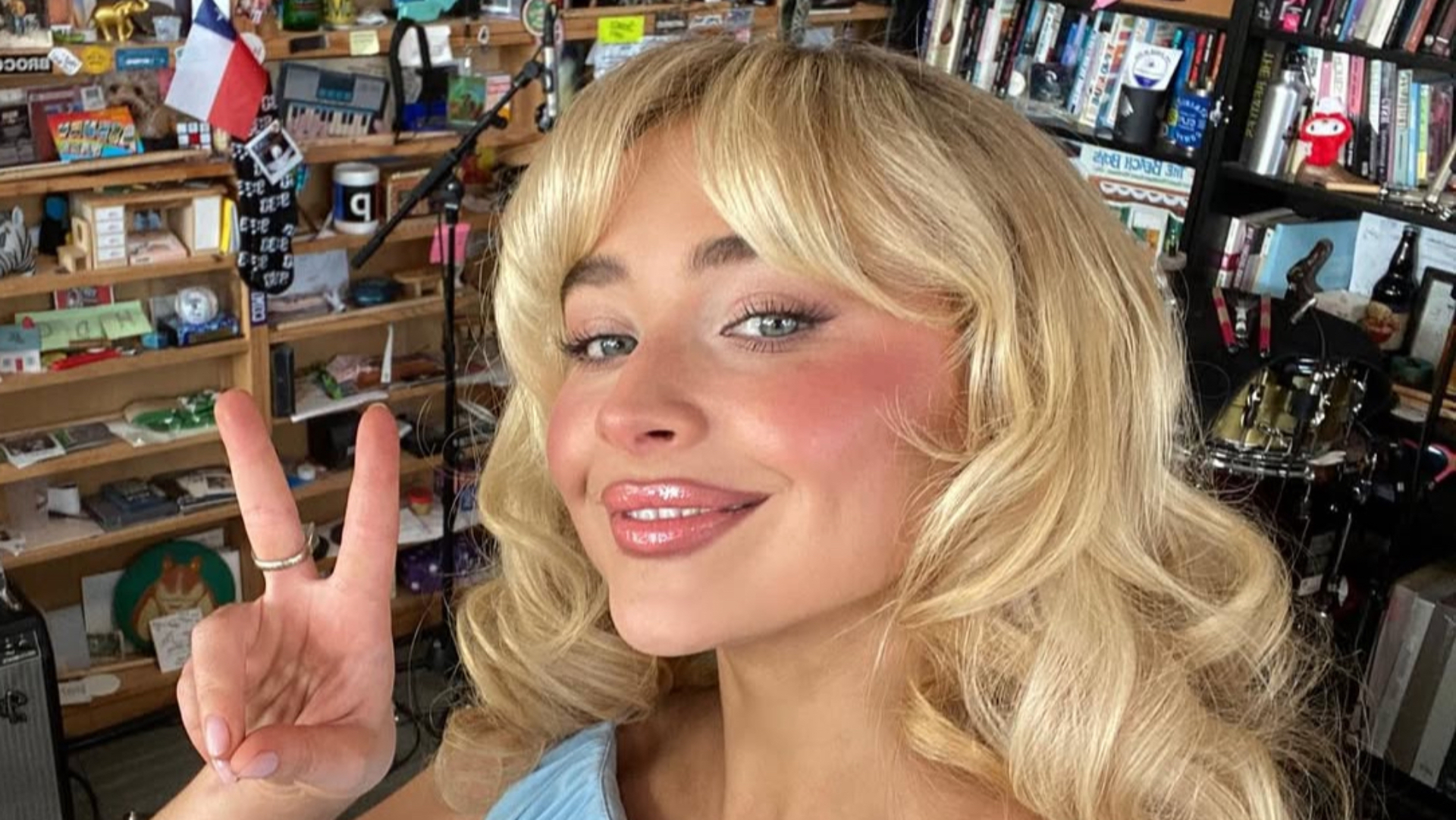 Sabrina Carpenter holding up a peace sign