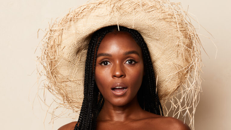 Janelle Monae wearing a straw hat