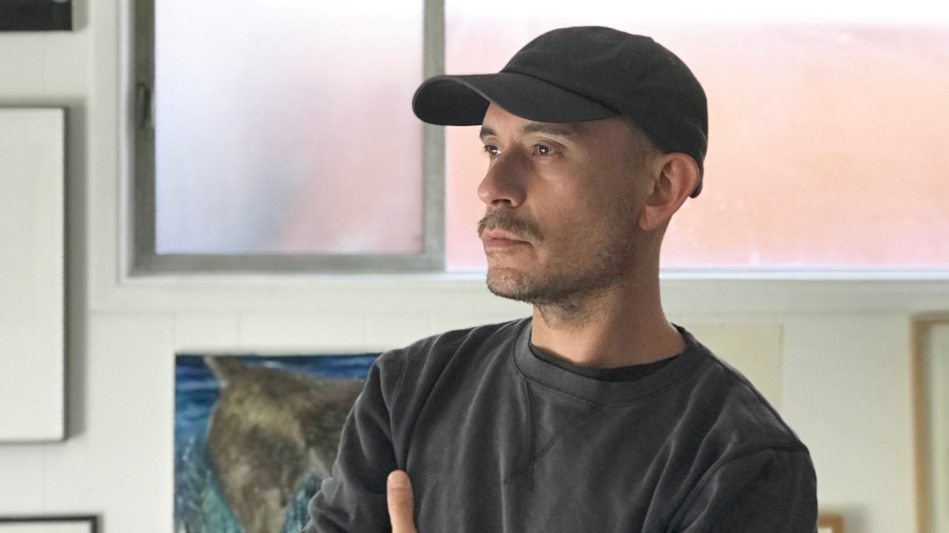 Portrait shot of a man wearing a dark cap and T-shirt
