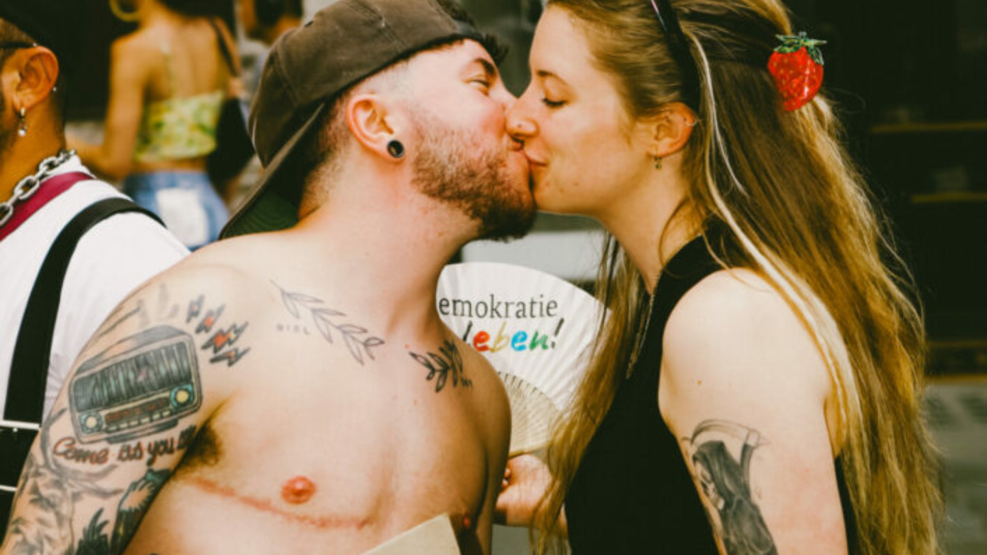 Trans man kissing a woman