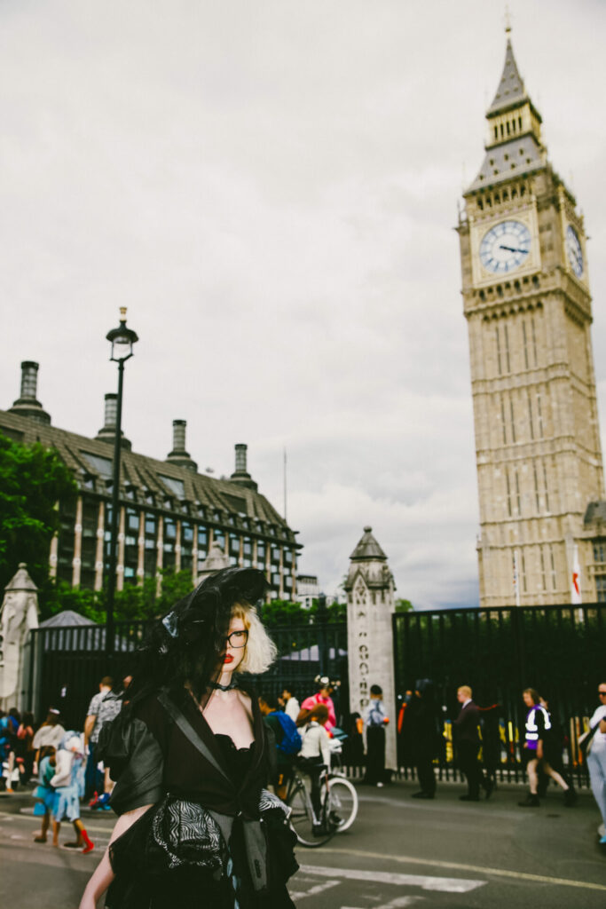 A protester wearing a black dress walks in front of Big Ben in London