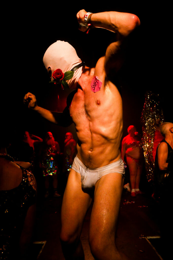 Man in just a pair of white briefs and a mask at NYC Downlow 2025