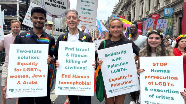 Peter Tatchell foundation at Pride in London holding up signs saying 'End Israel and Hamas killing of civilians'