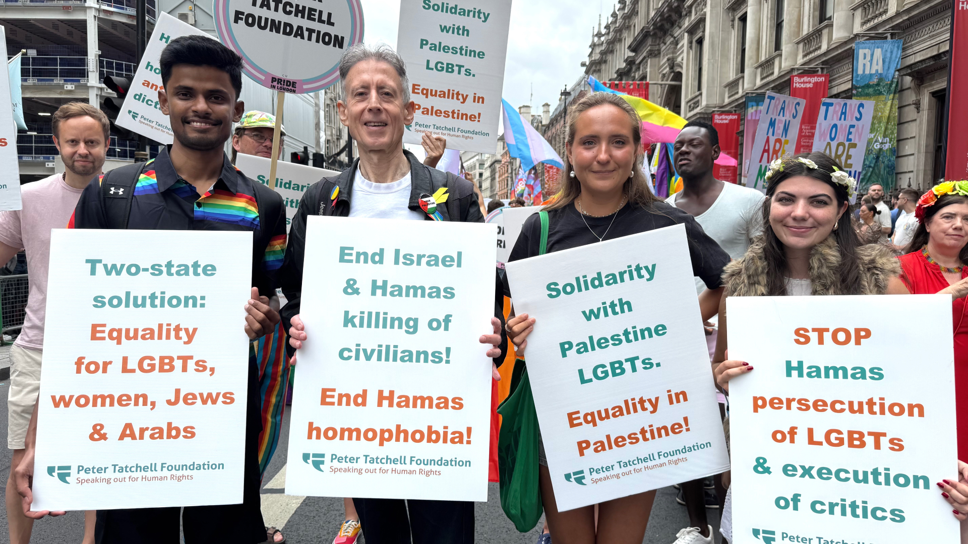 Peter Tatchell foundation at Pride in London holding up signs saying 'End Israel and Hamas killing of civilians'