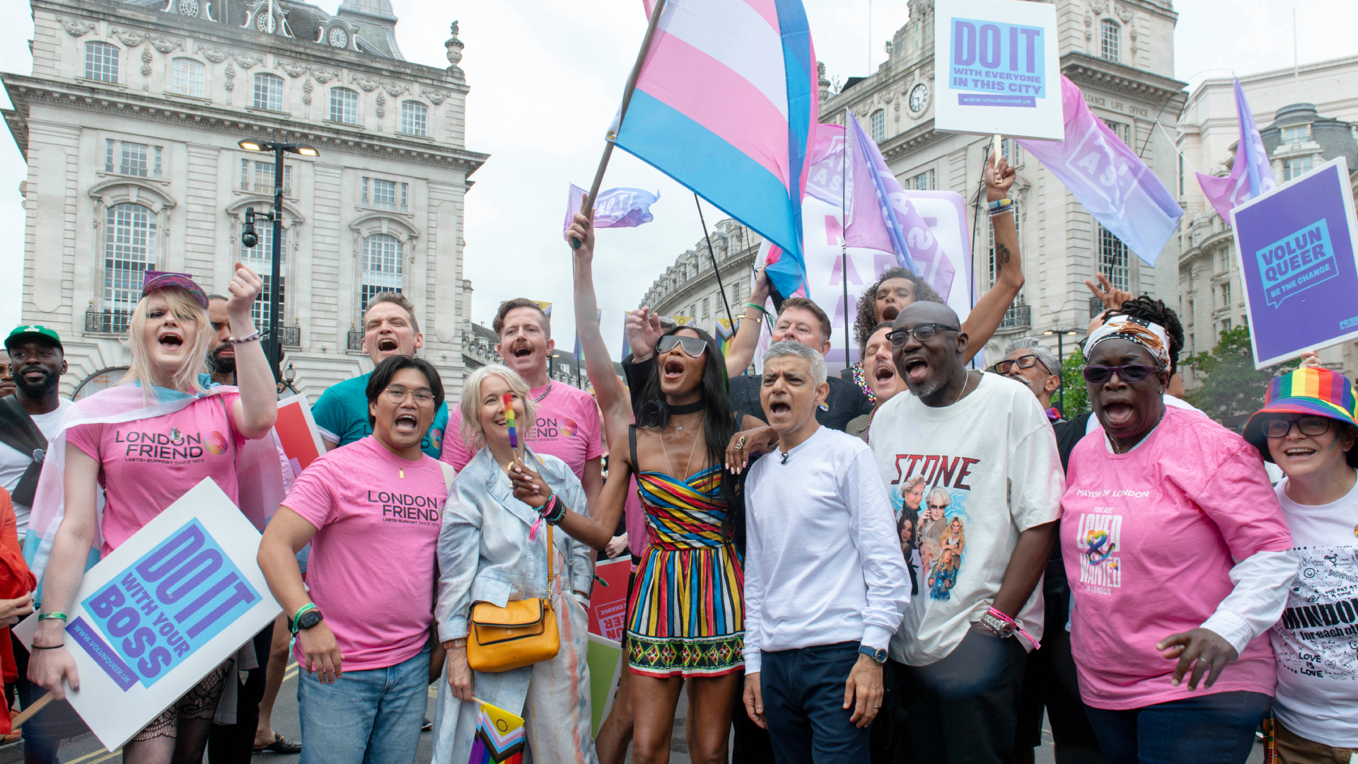 Naomi Campbell with Sadiq Khan at Pride in London in a crowd of people flying a trans flag