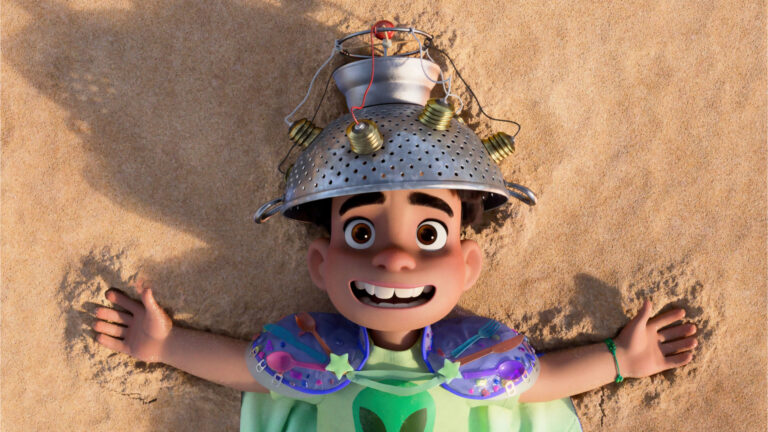 Elio cartoon lying on sand with a sieve on his head