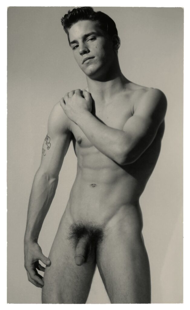 a man naked with penis visible and arm on shoulder