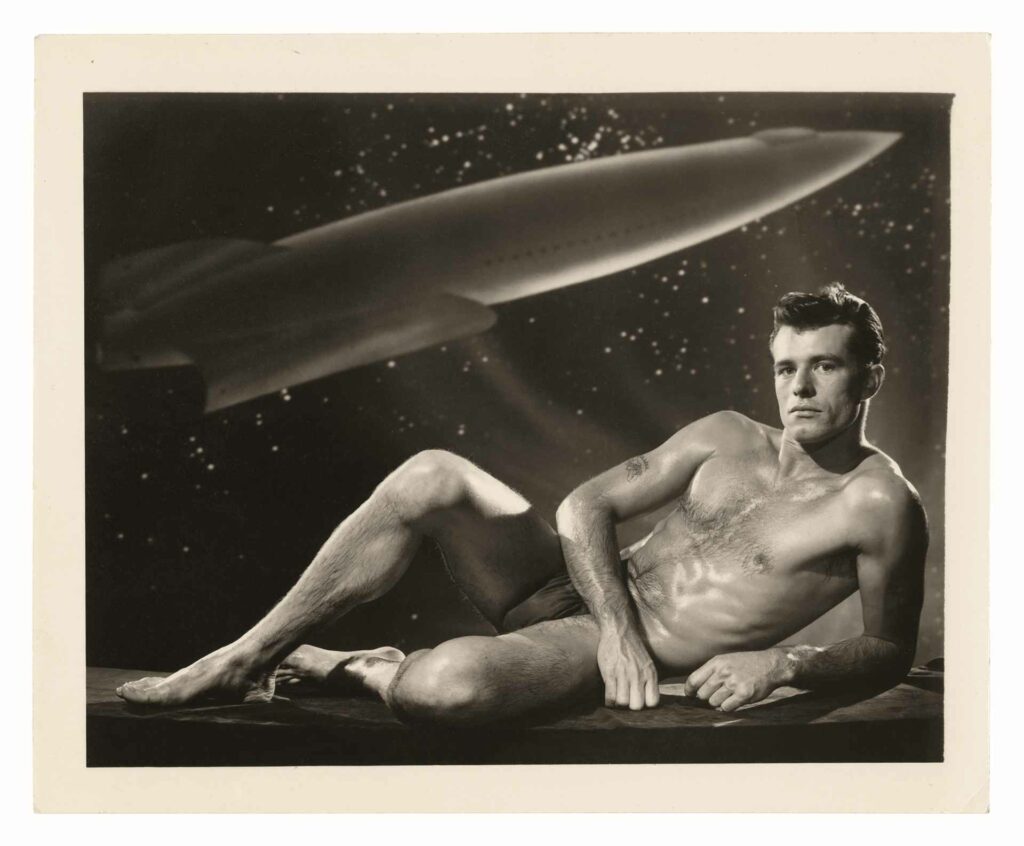 A sepia toned photo of a muscular man posing