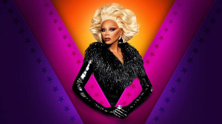 RuPaul in a blonde wig and black feathered sequinned dress