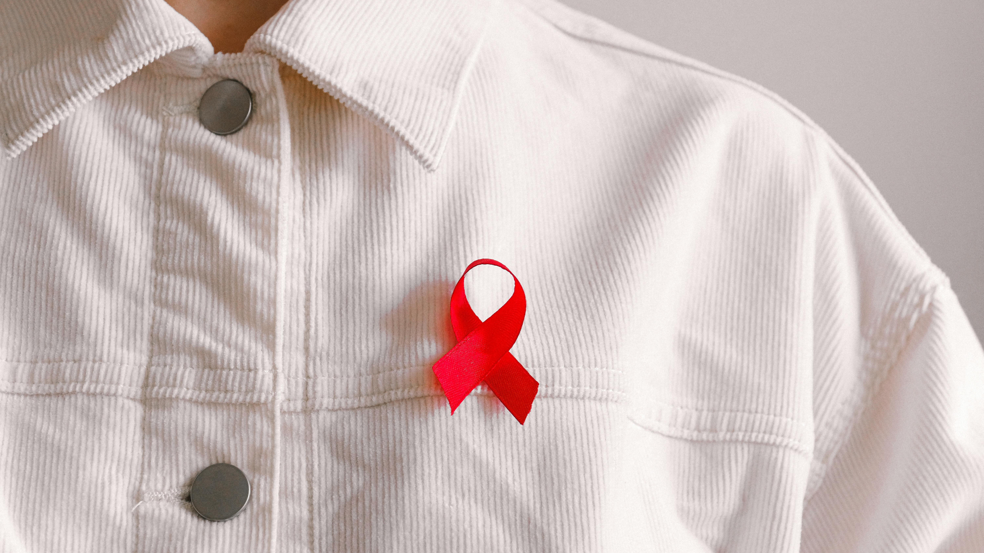 HIV/AIDS awareness badge on white shirt