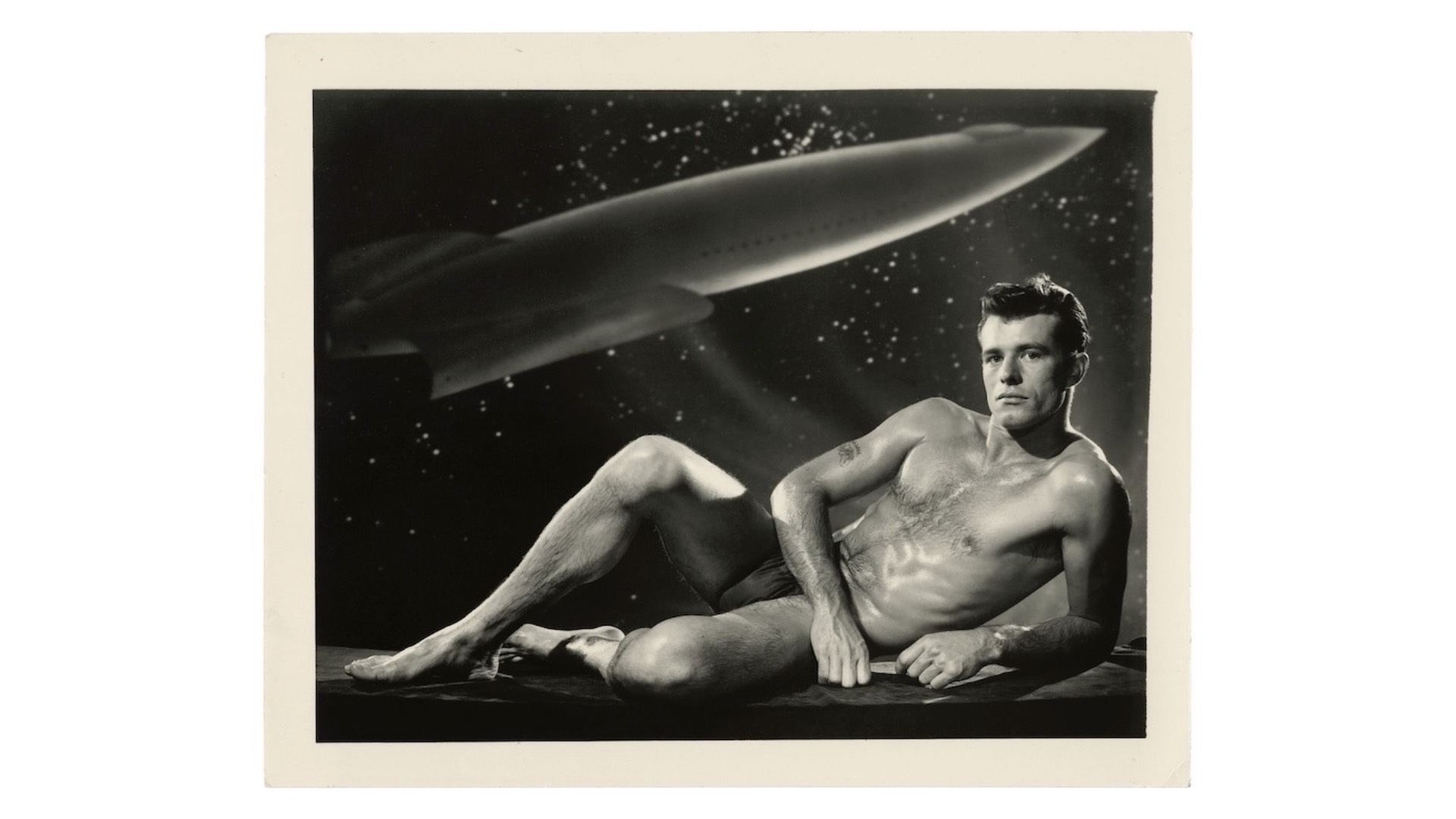 a pic of a nude man with a planet in the background