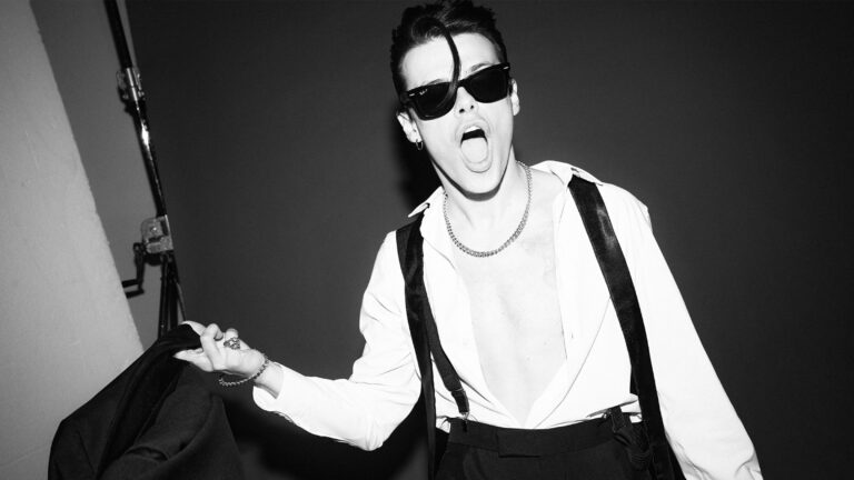 yungblud in white shirt, black shares and black braces