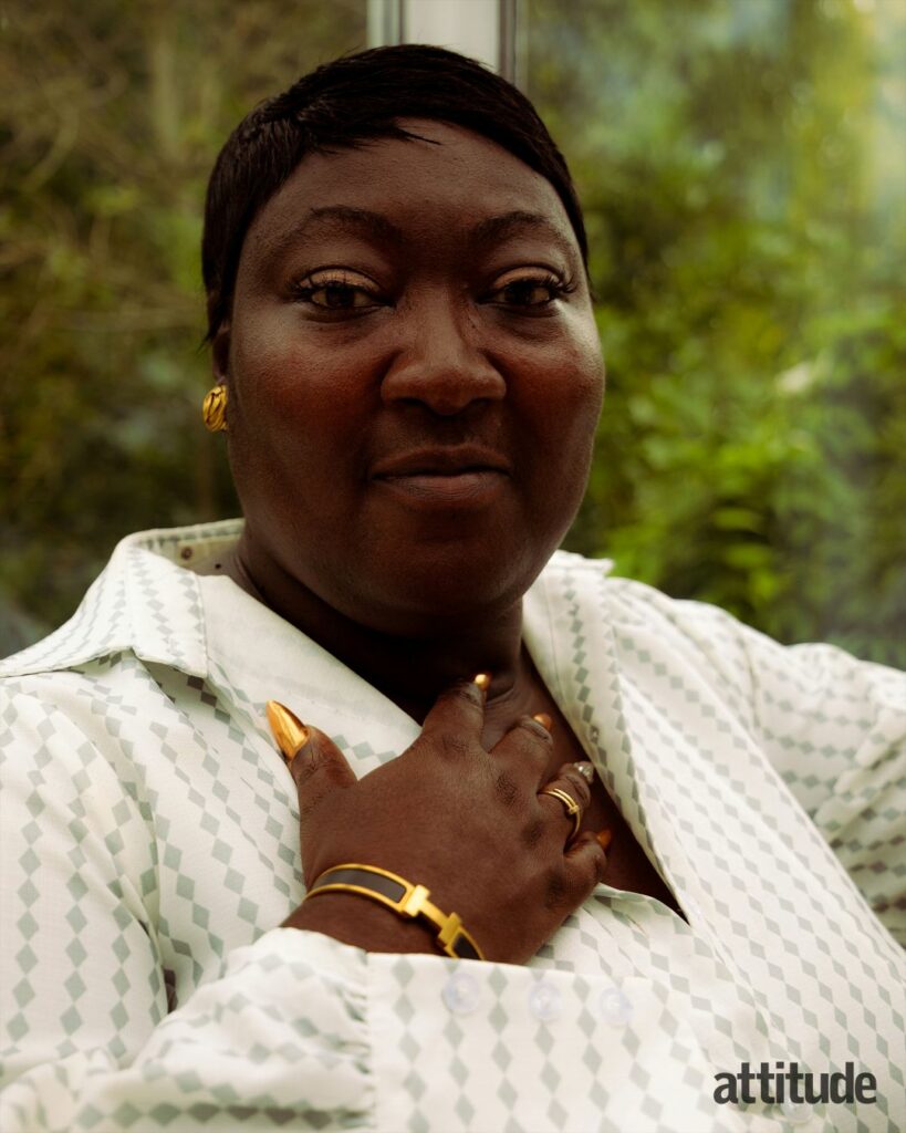 Lady Phyll looking into the camera with one hand held on her chest