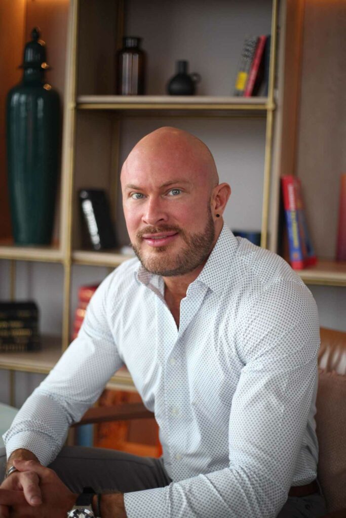 A smiling man wearing a white shirt