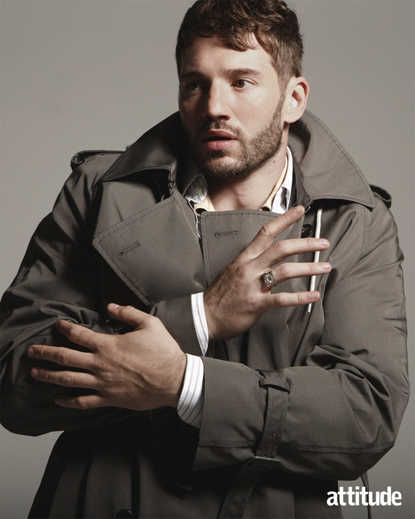 Alexander in a brown coat and white shirt looking to the left