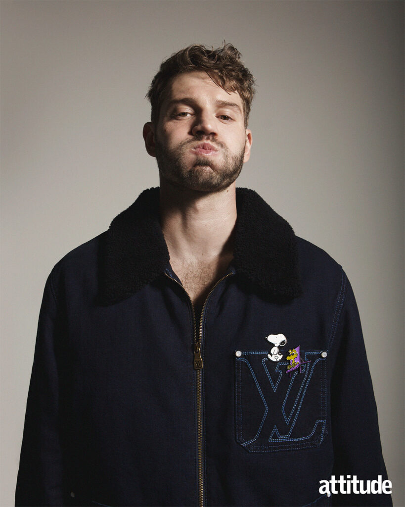 Alexander Lincoln in the new issue of attitude, in a blue jacket pulling a funny face