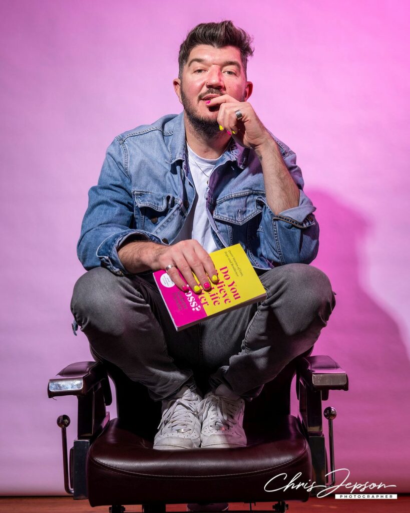 A person wearing denim sitting in a barber's chair