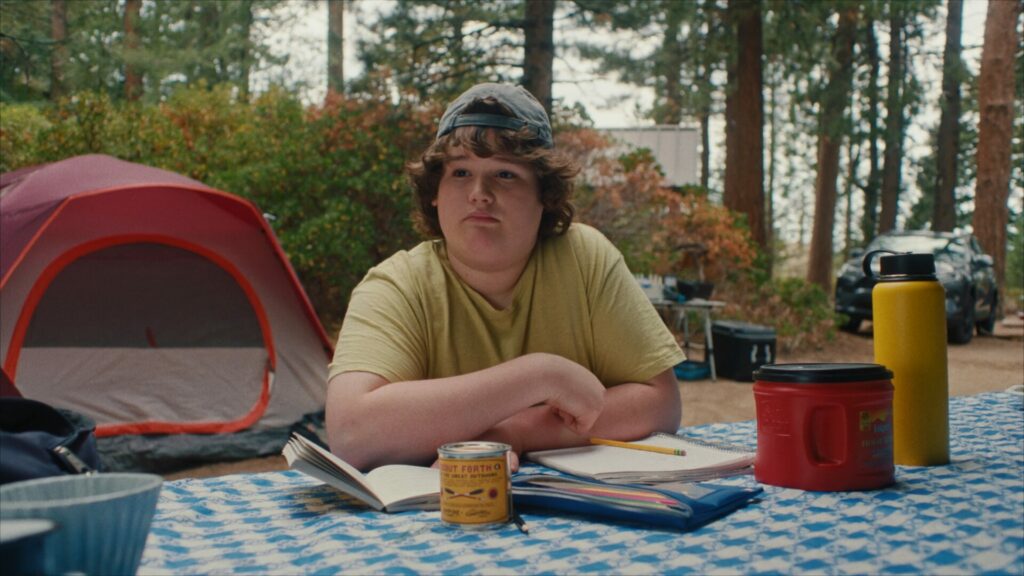 Isaac Krasner sat at a picnic bench in a camping site