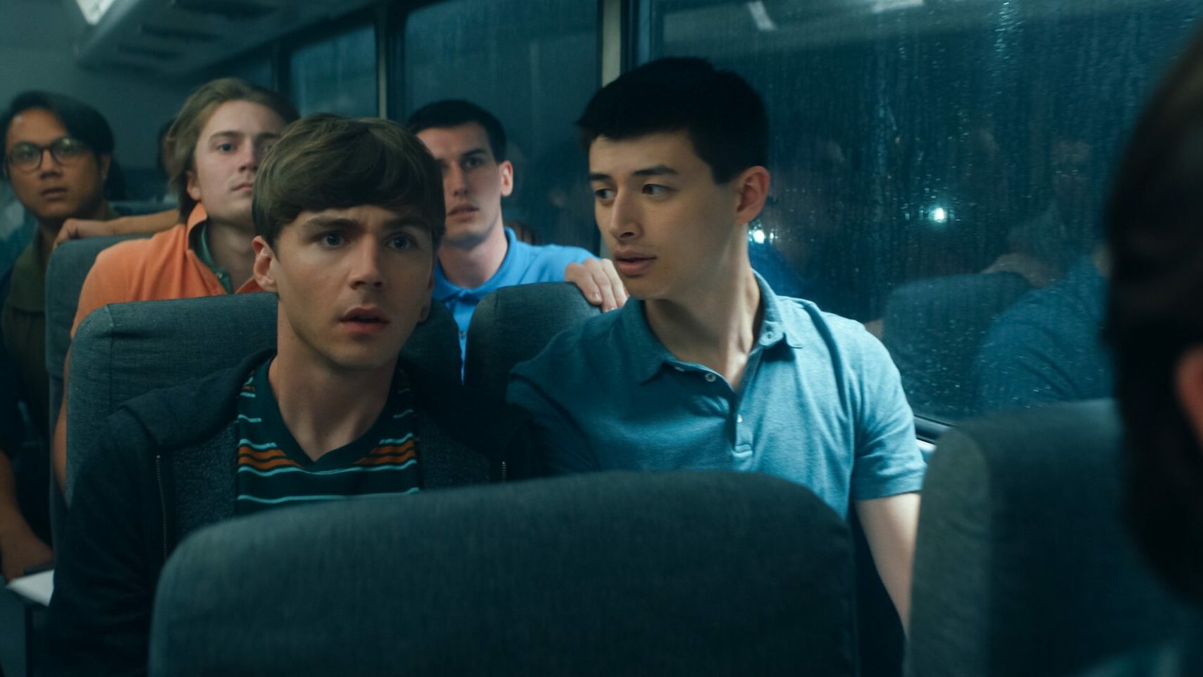 Heizer with Liam Oh as Ray McAffey sitting on a bus (Image: Netflix)