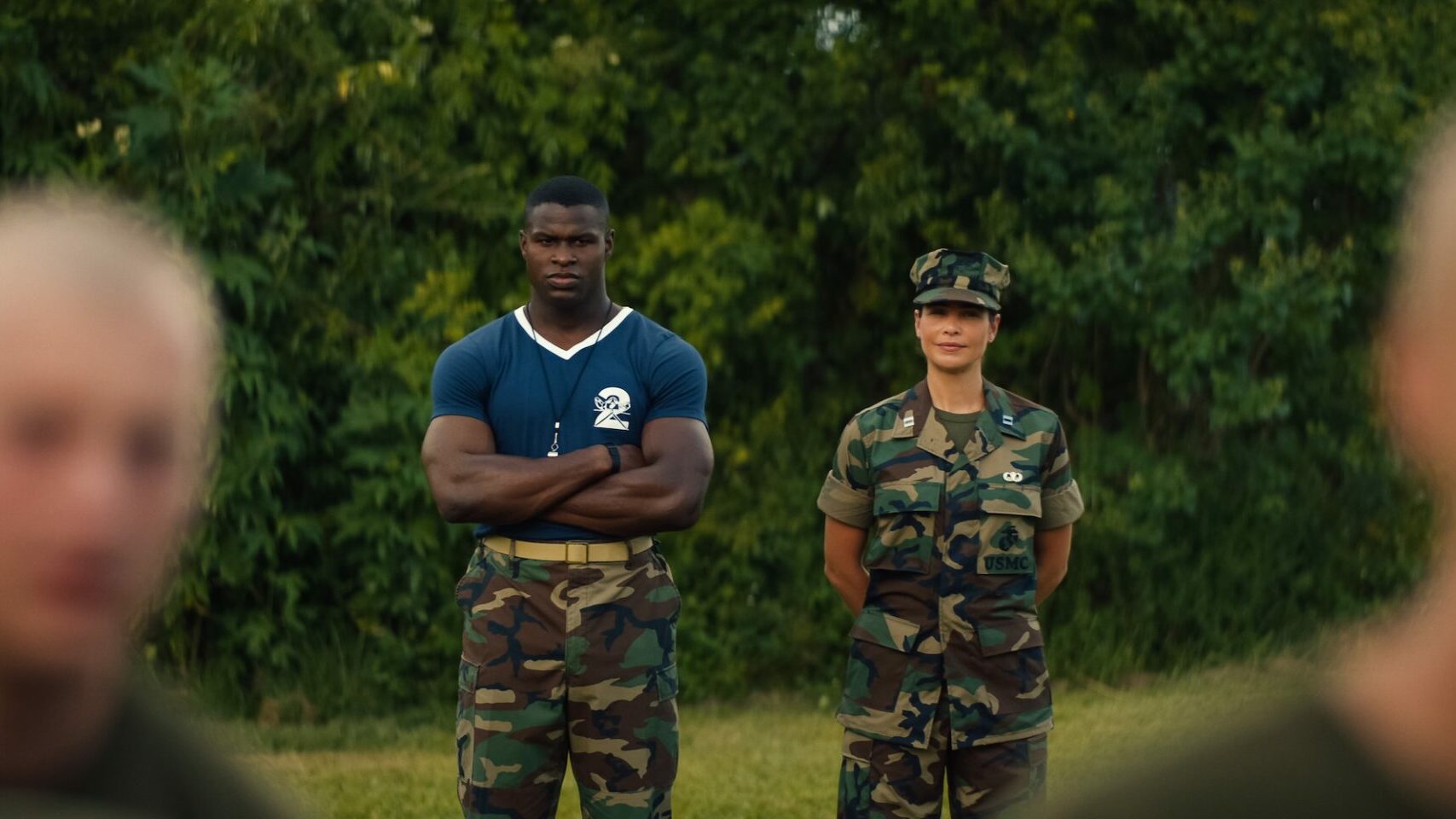 Cedrick Cooper as Sgt. McKinnon and Ana Ayora as Captain Fajaro standing before some greenery(Image: Netflix)