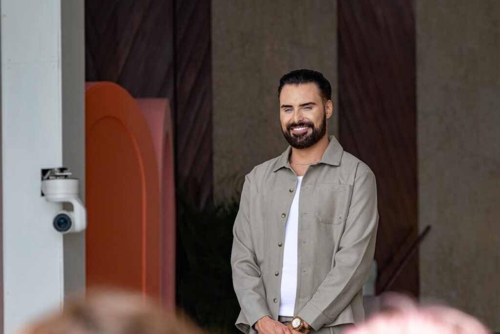 Rylan Clark smiling in a green jacket