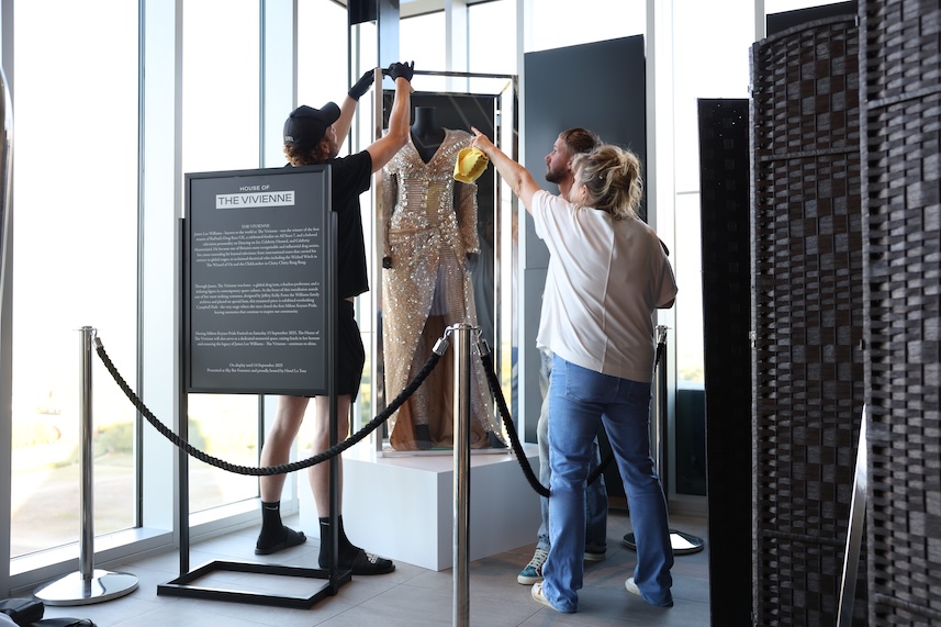 Three people taking photographs of The Vivienne's dress