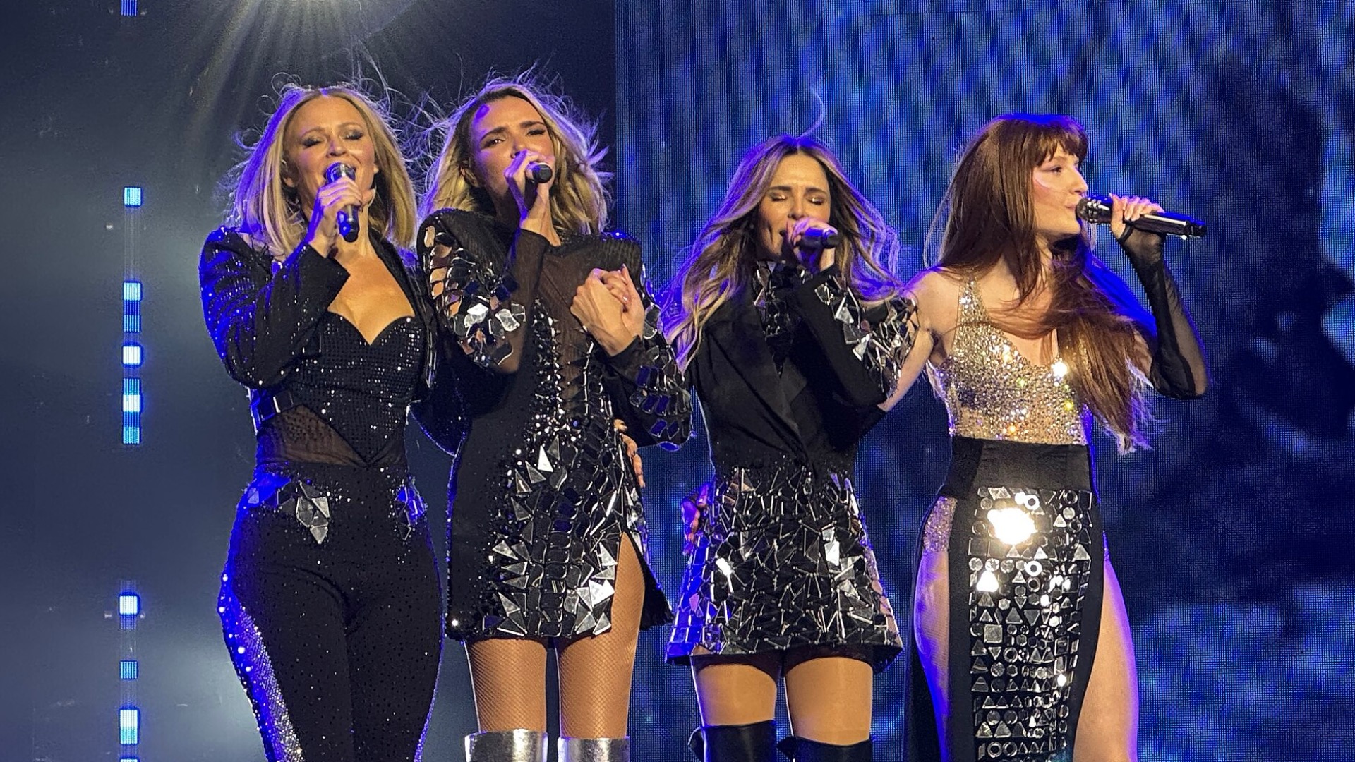 Girls Aloud remaining members dressed in black sparkly outfits at their 2024 UK tour