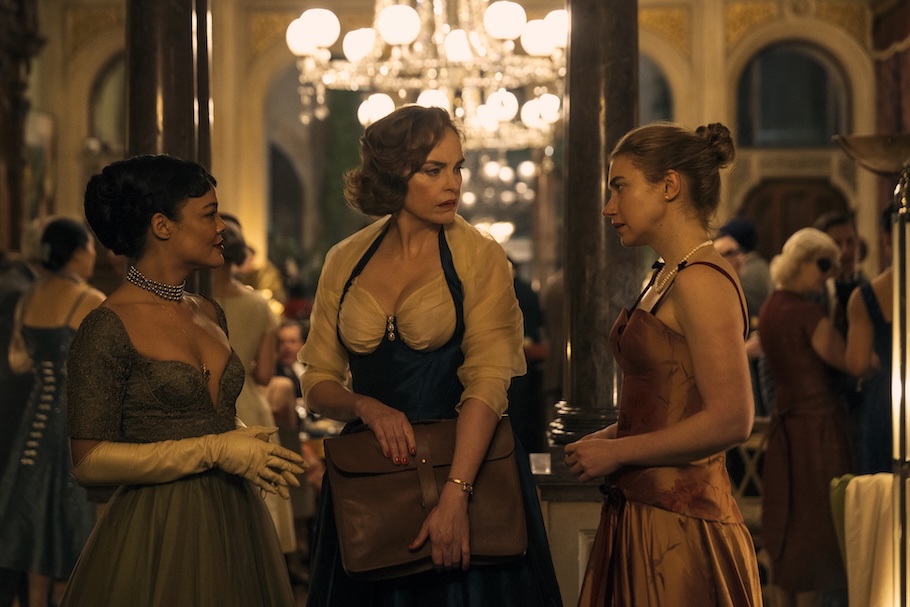 (L-R): Hedda Gabler (Tessa Thompson), Eileen Lovborg (Nina Hoss), Thea Clifton (Imogen Poots) in HEDDA having a conversation dressed in ball gowns