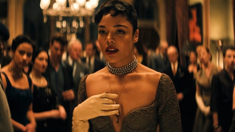 Tessa Thompson wearing a white glove with her hand clutched to her chest