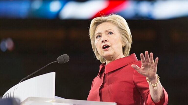 Hillary Clinton dressed in red speaking at one of her 2016 presidential campaigns