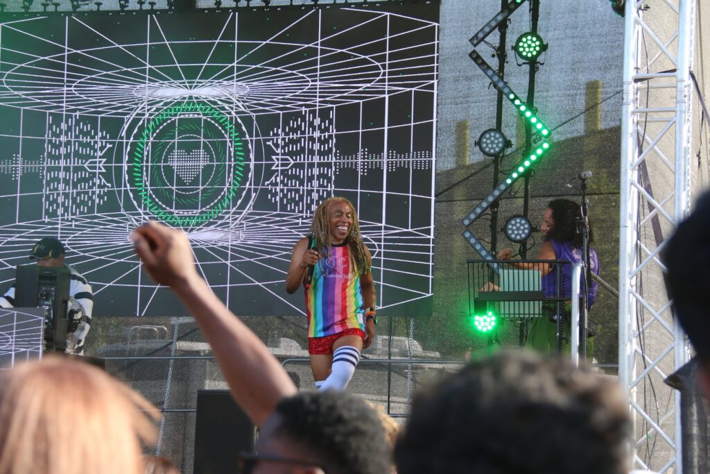 Man in a rainbow vest dancing on stage at UK Black Pride 2025