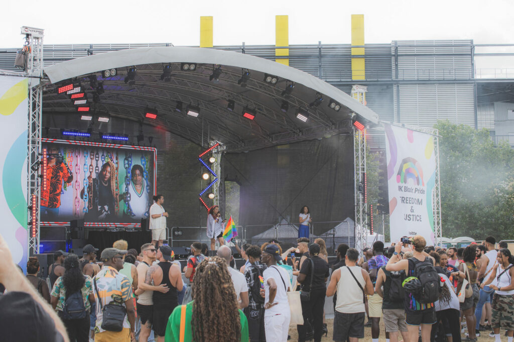 UK Black Pride stage with crowds of people watching acts perform
