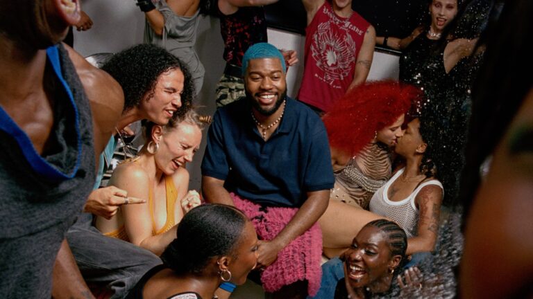 Khalid surrounded by people at a party