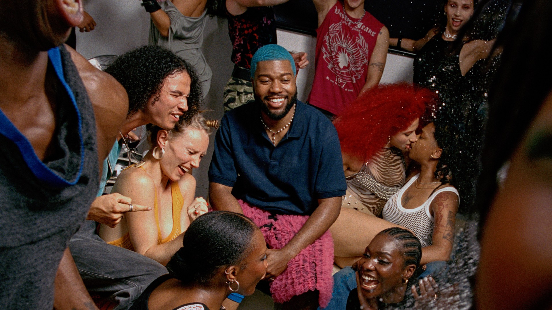 Khalid surrounded by people at a party