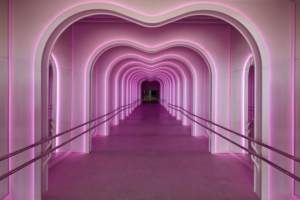 the pink neon hallway in sls Barcelona, long with multiple arches