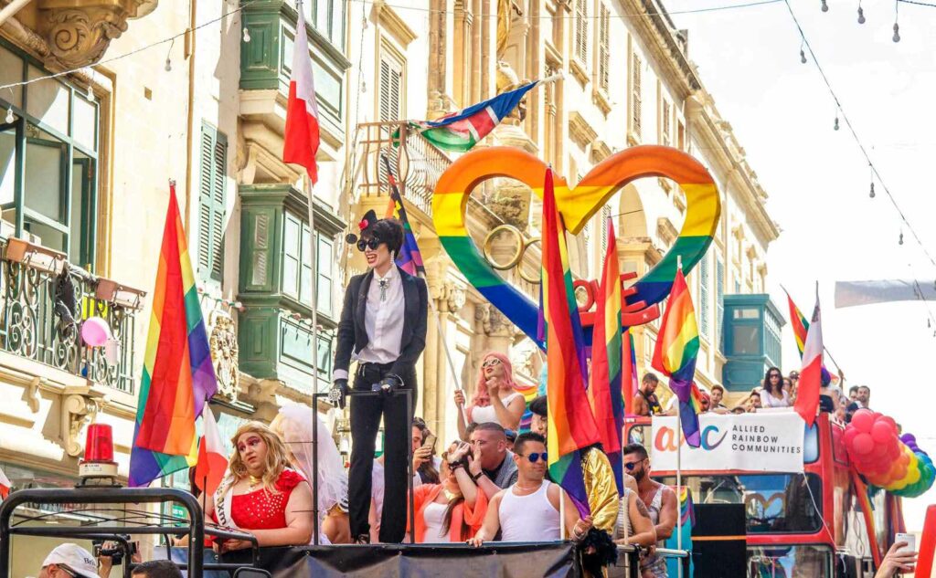 A float in Malta Pride filled with people and colourful decorations