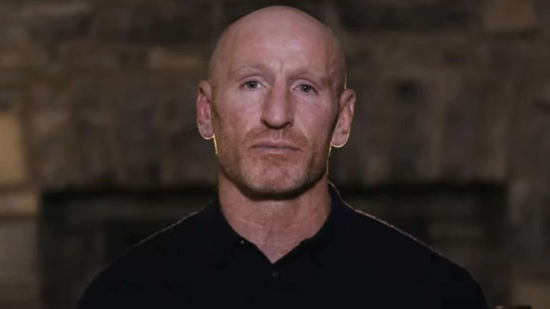 Gareth Thomas dressed in black seriously looking at the camera