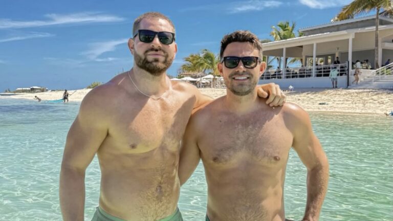 Jaymes Vaughan and Jonathan Bennett standing topless in their swim wear on holiday at the beach