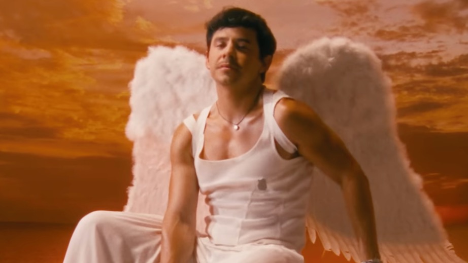 David Archuleta wearing angel wings, a white west and white trousers