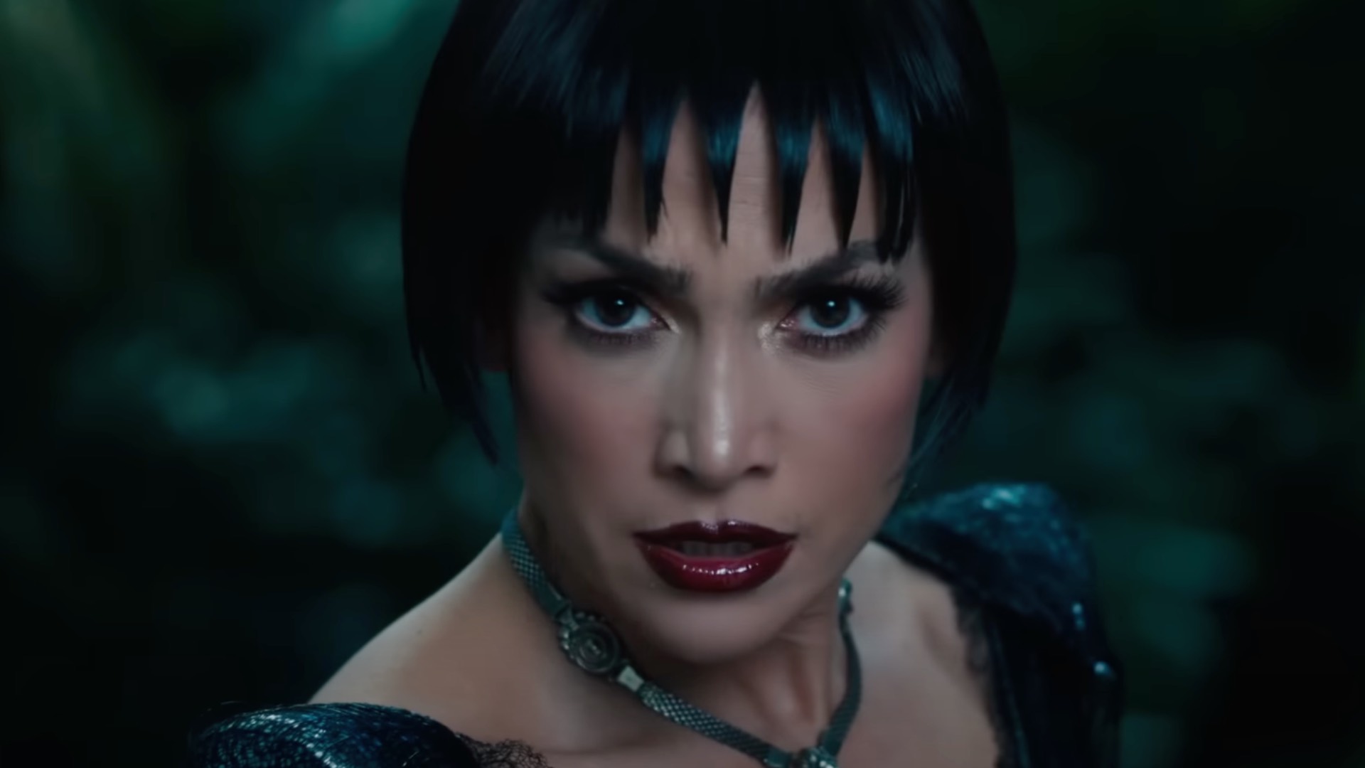 Jennifer Lopez in Kiss of the Spider Woman film wearing a black short wig and red lipstick