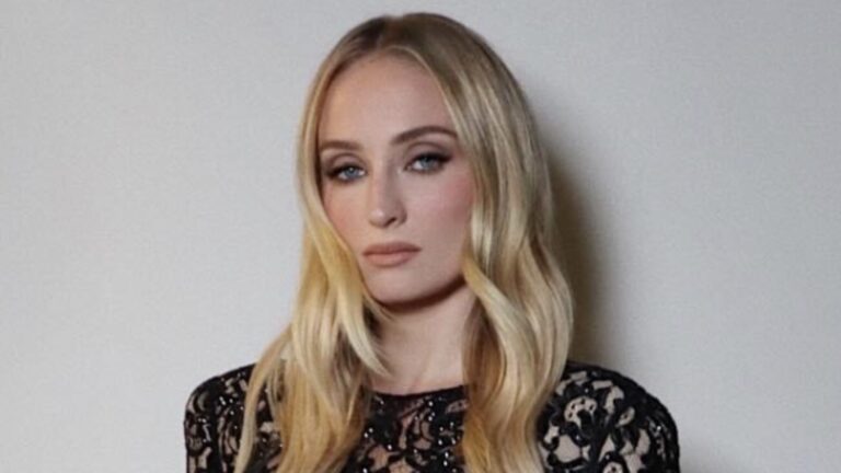 Sophie Turner wearing a black lace dress and dark eye makeup